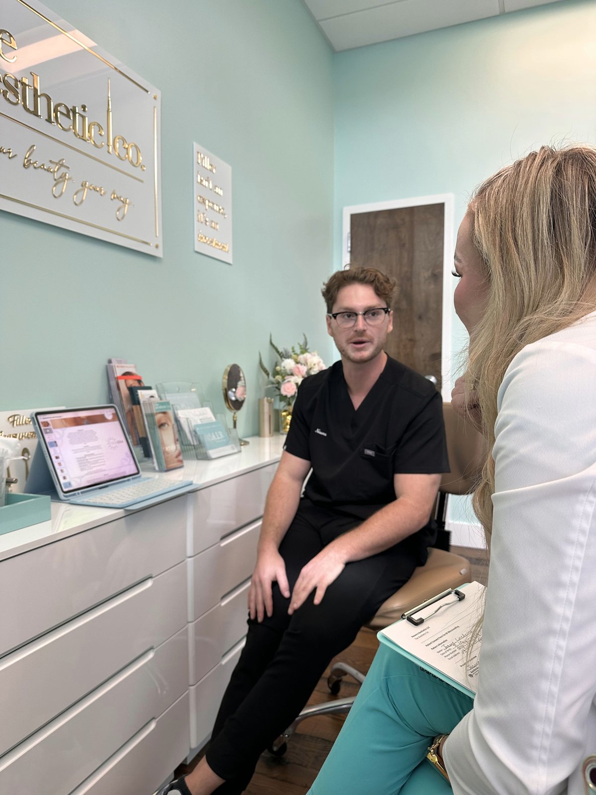 Nathan Shalom consulting with a provider inside a partner medspa